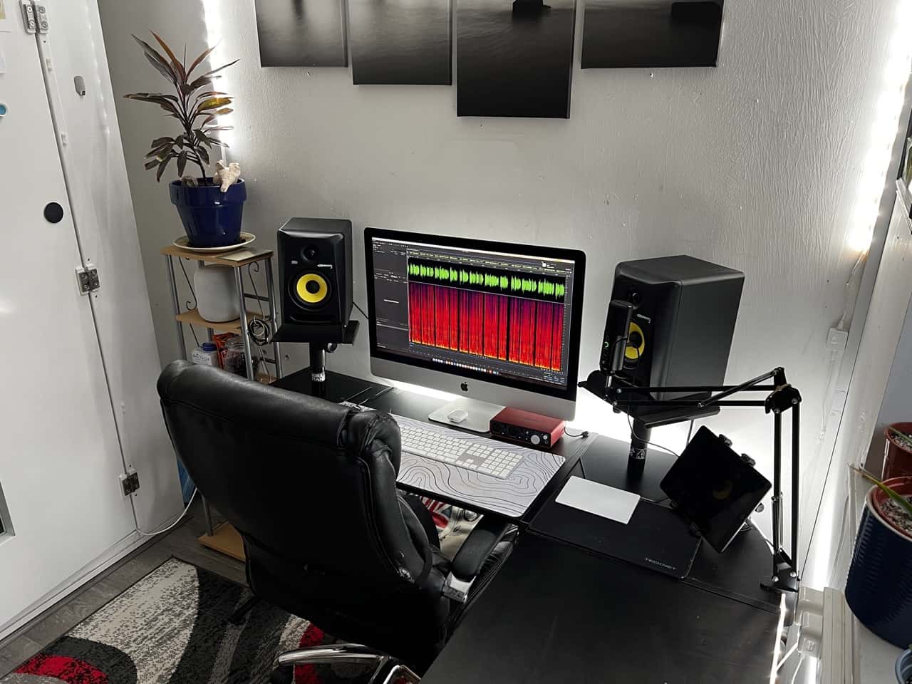 Close-up of the studio of Mark Thomas, a British VoiceOver artist in colour. There are two speakers and an iMac showing an audio way Close-up of the studio of Mark Thomas, a British VoiceOver artist in colour. There are two speakers and an iMac showing an audio waveform